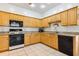 Kitchen featuring wood cabinets, tiled flooring, and modern appliances at 892 Cool Springs Cir, Ocoee, FL 34761