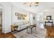 Living room showcasing hardwood floors, neutral walls, and a sofa with side table at 892 Cool Springs Cir, Ocoee, FL 34761
