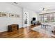Living room with hardwood floors, media center, and large windows at 892 Cool Springs Cir, Ocoee, FL 34761
