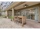 Covered patio showcasing brick floors, a high-top table, ceiling fans and view to home's interior at 892 Cool Springs Cir, Ocoee, FL 34761