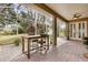 Screened-in porch featuring brick flooring, ceiling fans, and view of backyard with lush landscaping at 892 Cool Springs Cir, Ocoee, FL 34761
