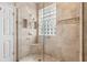 Tiled shower featuring glass block window and built-in shelves at 892 Cool Springs Cir, Ocoee, FL 34761