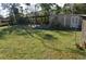 Spacious backyard featuring a wooden pergola, storage shed, and ample space for outdoor activities at 933 Lakehurst St, Lakeland, FL 33805