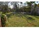 The backyard features a covered table, lush grass and mature trees at 933 Lakehurst St, Lakeland, FL 33805