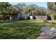 A view of the backyard with shed, lattice structure and covered area at 933 Lakehurst St, Lakeland, FL 33805