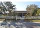 Charming single-story home with a white picket fence and screened porch at 933 Lakehurst St, Lakeland, FL 33805