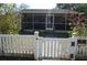 Charming home with white picket fence and a screened-in porch at 933 Lakehurst St, Lakeland, FL 33805