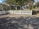 Charming home featuring a well-manicured front yard with a white picket fence and driveway at 933 Lakehurst St, Lakeland, FL 33805