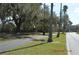 Walking path next to street bordered by grass and trees draped with spanish moss at 933 Lakehurst St, Lakeland, FL 33805