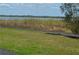 Lush waterfront features grassy lawn, bulrushes, and beautiful lake at 933 Lakehurst St, Lakeland, FL 33805