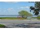 Scenic waterfront view features lake, trees, recreation area, and blue skies at 933 Lakehurst St, Lakeland, FL 33805