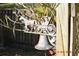 Close-up of a charming metal horse and carriage yard ornament with a rustic bell, adding character to the outdoor space at 933 Lakehurst St, Lakeland, FL 33805