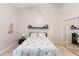 Bedroom featuring a bed with floral bedding and a mirrored closet at 1075 Kensington Park Dr # 203, Altamonte Springs, FL 32714