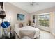 Well-lit bedroom with a ceiling fan and views from the large window at 1075 Kensington Park Dr # 203, Altamonte Springs, FL 32714