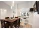 View of a dining room with dark wood table, hardwood floors, and an eat-in counter with barstools at 1075 Kensington Park Dr # 203, Altamonte Springs, FL 32714