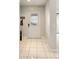 Bright foyer with tile flooring, white trim, and decorative front door at 1075 Kensington Park Dr # 203, Altamonte Springs, FL 32714