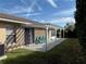 Rear patio with pergola and a view of the green backyard at 10753 Wilderness Ct, Orlando, FL 32821