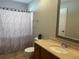 Bathroom with vanity, toilet, and shower with decorative curtain at 10753 Wilderness Ct, Orlando, FL 32821