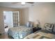 Bedroom features twin beds, tile floors, ceiling fan and lots of natural light at 10753 Wilderness Ct, Orlando, FL 32821