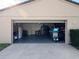 A spacious garage with ample storage space and an open door at 10753 Wilderness Ct, Orlando, FL 32821