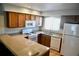 Functional kitchen features a gas range, ample counter space, and traditional wood cabinets at 10753 Wilderness Ct, Orlando, FL 32821