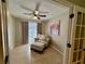 Cozy sitting room with tiled floor, comfortable chair and ottoman, ceiling fan, and natural light at 10753 Wilderness Ct, Orlando, FL 32821