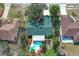 Aerial view of home showcasing a backyard pool, patio, mature trees, and vibrant landscaping at 1113 Lyric Dr, Deltona, FL 32738