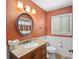 Cozy bathroom with stylish lighting, a mirror, a vanity, and a toilet at 1113 Lyric Dr, Deltona, FL 32738