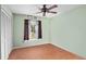 Bright bedroom with a ceiling fan, a window with curtains, and a spacious closet at 1113 Lyric Dr, Deltona, FL 32738