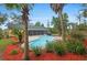 A beautiful backyard swimming pool surrounded by tropical foliage with views of the house at 1113 Lyric Dr, Deltona, FL 32738