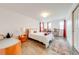 Bright bedroom with wood floors, neutral walls, and red accents at 11604 Acosta Ave, Orlando, FL 32836