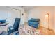 Bedroom features comfortable blue armchair, patterned rug, and ample closet space, creating a cozy retreat at 11604 Acosta Ave, Orlando, FL 32836