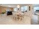 Open-concept dining area with wood accent wall and large windows providing abundant natural light at 11604 Acosta Ave, Orlando, FL 32836