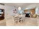 Dining area flowing into a cozy living space, featuring tile floors and ample seating at 11604 Acosta Ave, Orlando, FL 32836