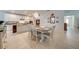 Kitchen and dining area offering white cabinets, tile flooring and a dining table set for six at 11604 Acosta Ave, Orlando, FL 32836