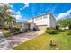 Charming two-story home with a covered porch, well-manicured lawn, and a brick-paved driveway at 11604 Acosta Ave, Orlando, FL 32836