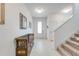 Bright foyer features tile floors, a decorative bench, and stairway to the second floor at 11604 Acosta Ave, Orlando, FL 32836