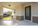 Inviting front porch featuring rocking chairs and a stylish front door with glass inserts at 11604 Acosta Ave, Orlando, FL 32836