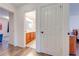 Hallway view showcases bathroom with wood cabinets, double sinks, and tile flooring and bedroom on other side at 11604 Acosta Ave, Orlando, FL 32836