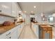 Kitchen featuring white cabinets, subway tile backsplash, granite countertops and a central island at 11604 Acosta Ave, Orlando, FL 32836