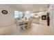 Kitchen and dining area filled with white cabinets, matching chairs and tile flooring at 11604 Acosta Ave, Orlando, FL 32836