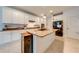 Kitchen featuring large island with granite countertops, white cabinets, and modern stainless steel appliances at 11604 Acosta Ave, Orlando, FL 32836