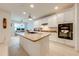 Well-lit kitchen showcasing a large island with granite countertops, white cabinetry, and modern appliances at 11604 Acosta Ave, Orlando, FL 32836