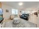 Bright living room featuring neutral walls, tile floors, and comfortable seating arrangement with stylish area rug at 11604 Acosta Ave, Orlando, FL 32836