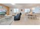 Spacious living area featuring tile floors, a decorative rug, and an adjacent dining area at 11604 Acosta Ave, Orlando, FL 32836