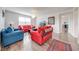 Bright living room with contemporary furnishings, wood flooring, and a view to the next room at 11604 Acosta Ave, Orlando, FL 32836