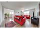 Bright living room with wood floors, modern furniture, and natural light streaming through the windows at 11604 Acosta Ave, Orlando, FL 32836