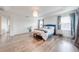 Stylish main bedroom with tray ceiling, wood floors, and modern décor accents at 11604 Acosta Ave, Orlando, FL 32836