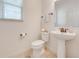 Powder room with pedestal sink and bronze fixtures at 11604 Acosta Ave, Orlando, FL 32836