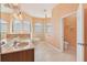 Bright bathroom features a double vanity, soaking tub, and private toilet room at 12018 Se 175Th Loop, Summerfield, FL 34491